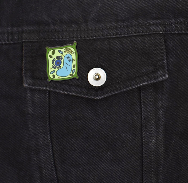 The plant cell pin is fastened to a black denim pocket. 