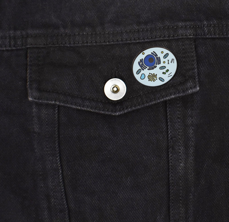 The blue pin is fastened to a black denim pocket. 