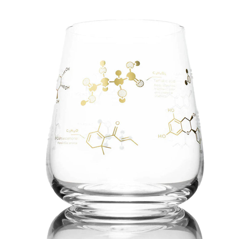 A stemless wine glass with the molecules and formula for wine in gold ink.