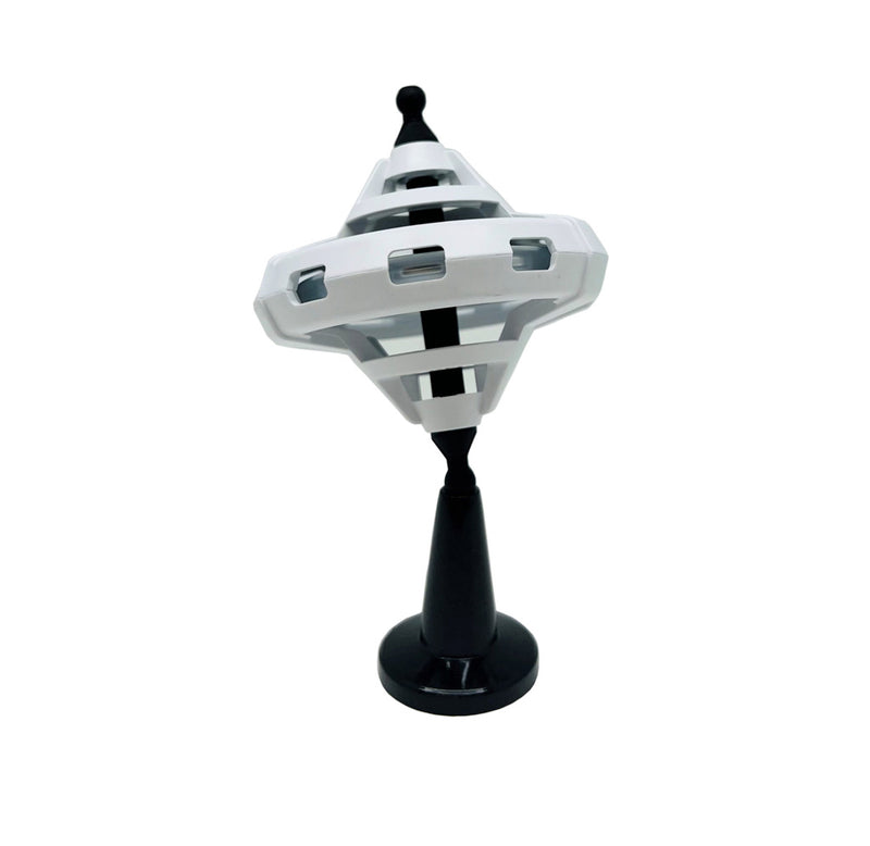 A white plastic gyroscope sitting on a black stand. 