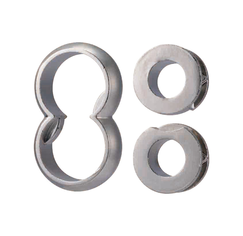 Three pieces of silver metal: two donut shapes and one in the outline of an 8. 