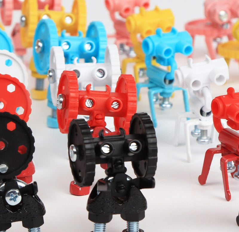 Built robot-like figures are lined up in rows. There are robots in black, red, white, blue, yellow, and pink. 