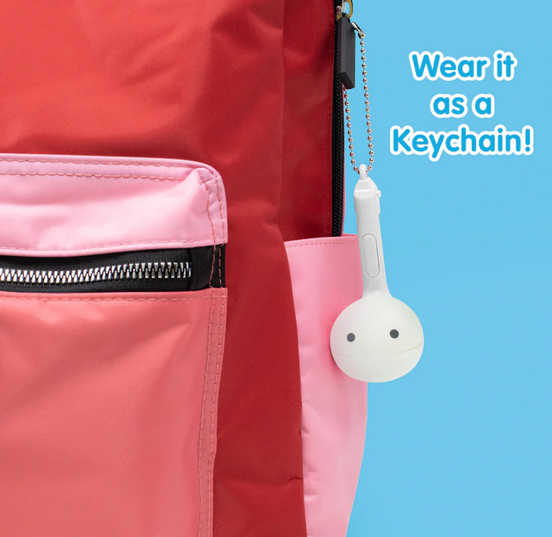 A white music note shaped toy is hung as a keychain on a red and pink backpack. 