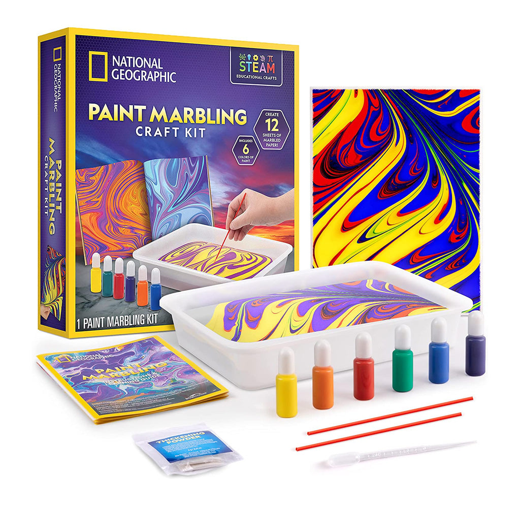 The product packaging, a white tray, six bottles of paints, some sticks, a dropper, a package, and a booklet are shown. There is also a paper with a swirling blue, yellow and red design on it. 