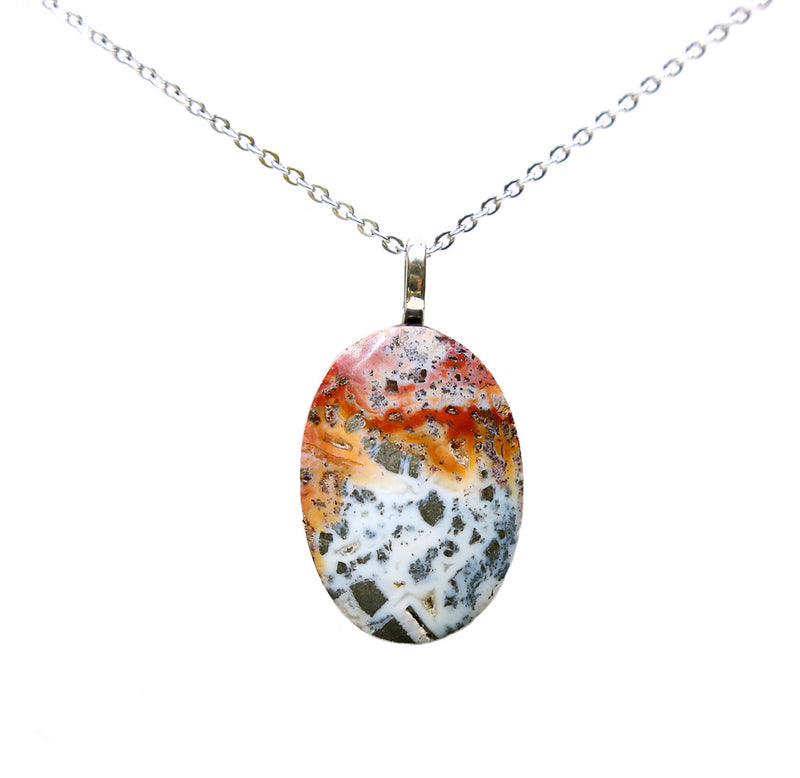 An oval stone pendant with colors of red, orange, white, and grey. The pendant is attached to a silver chain. 